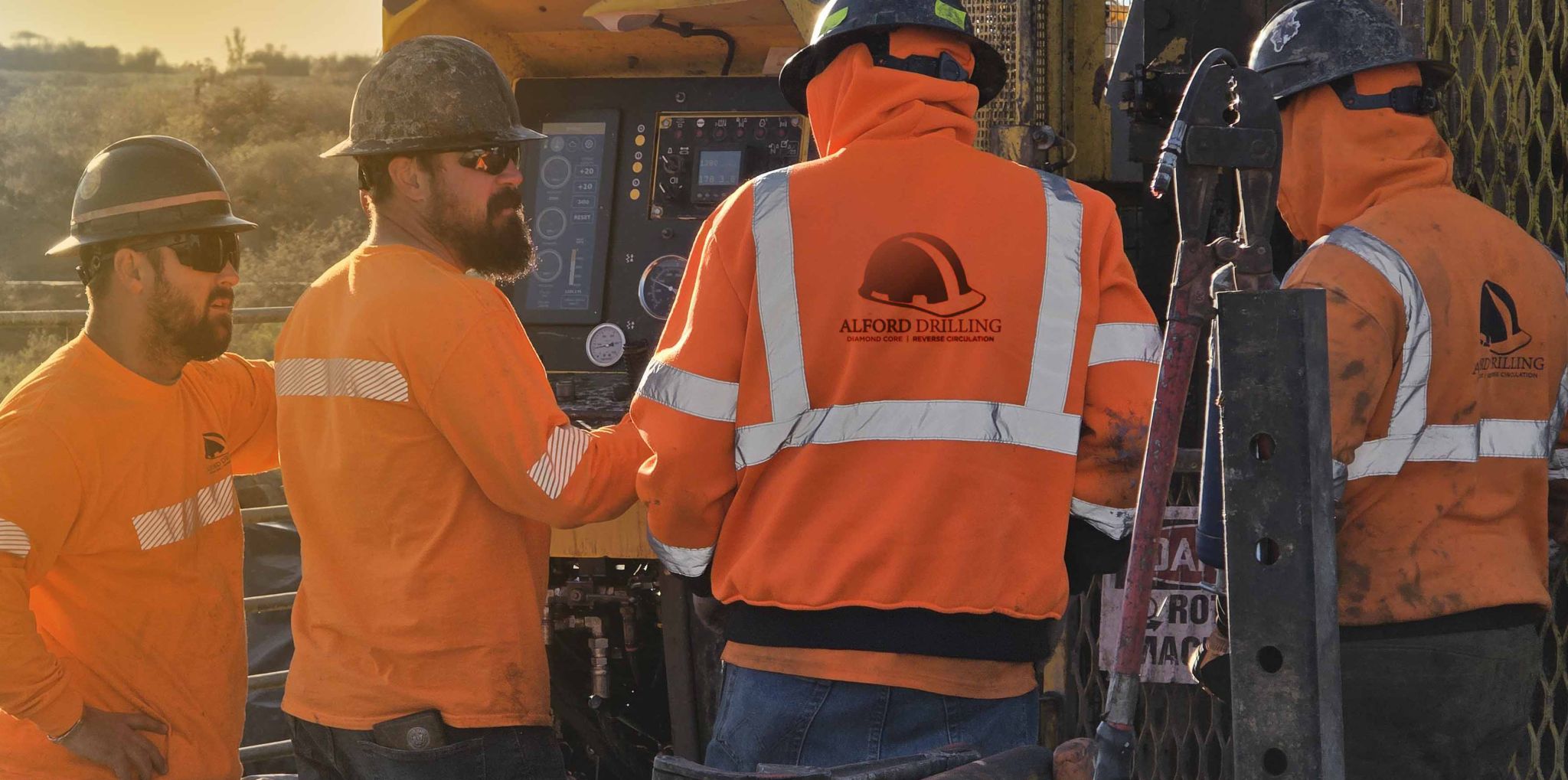 Alford Drilling crew handshake at drill site golden hour